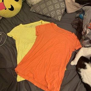 Two loft tees one orange and the other yellow